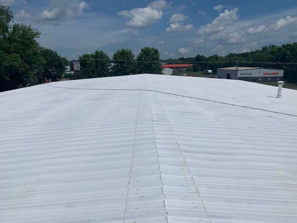 Professional metal roof restoration project with advanced coating system for maximum durability